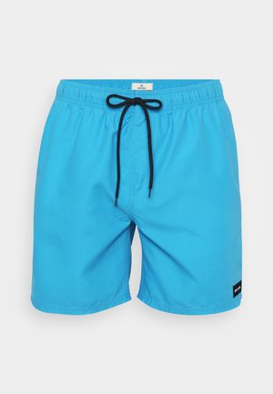 Siniset uimapuvut, joissa on joustava vyötärö, musta nauha ja sivusaumat. Alareunassa vasemmalla edessä on pieni musta logo-ominaisuus.