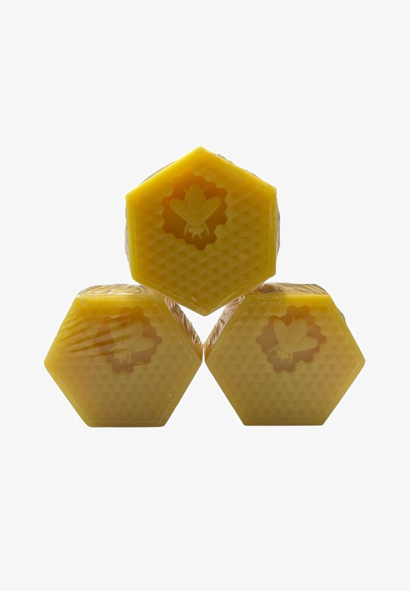 Three hexagonal blocks of yellow beeswax, featuring a honeycomb texture and embossed bee designs on the surface, each wrapped in clear plastic.