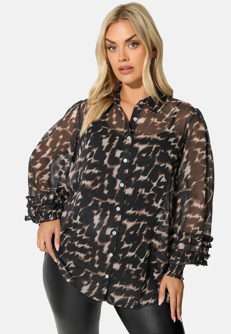 Blusa nera trasparente con stampa astratta marrone e crema, chiusura a bottoni davanti e maniche gonfiate di tessuto con dettagli arricciati.