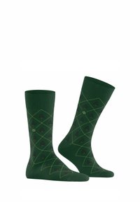 Grüne Socken mit einem Rautenmuster, das in Gelb umrandet ist, und kleinen roten Blumenakzenten. Hergestellt aus einem weichen, strukturierten Material.