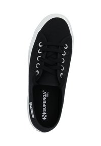 Black canvas sneaker with a rounded toe, white rubber sole, and six eyelets. Interior displays brand logo. Features black laces.