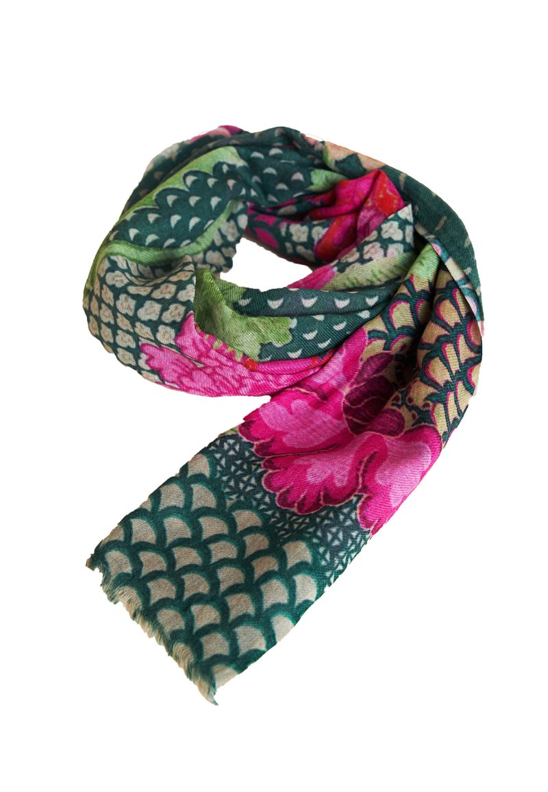 Soft scarf with green and beige scaled pattern, large pink and red floral prints, and fringed edges, loosely coiled on white background.