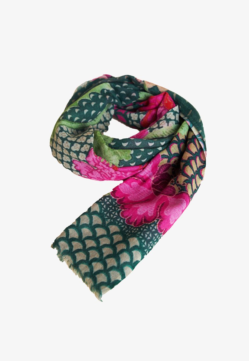 Soft scarf with green and beige scaled pattern, large pink and red floral prints, and fringed edges, loosely coiled on white background.