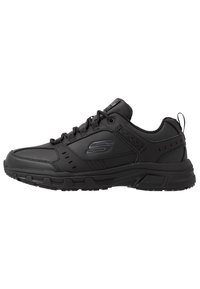 Black athletic shoes with a synthetic upper, lace closure, padded collar, textured detailing, and a rubber outsole for traction.