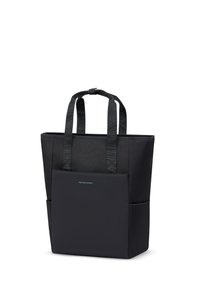 Sac fourre-tout noir Kapten & Son avec deux anses, poche avant et poches latérales, présenté debout sur fond blanc.