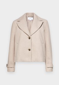 Beige cropped jacket made of a soft fabric, featuring a notched collar, two front pockets, and two large brown buttons.