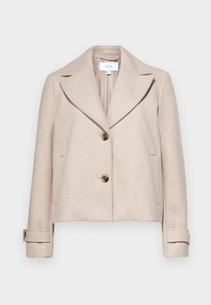 Beige cropped jacket made of a soft fabric, featuring a notched collar, two front pockets, and two large brown buttons.
