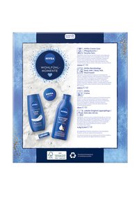 NIVEA set with blue packaging includes a 250ml bottle of Creme Care, a 400ml bottle of Body Milk, and a lip balm. Textured white and blue accents.