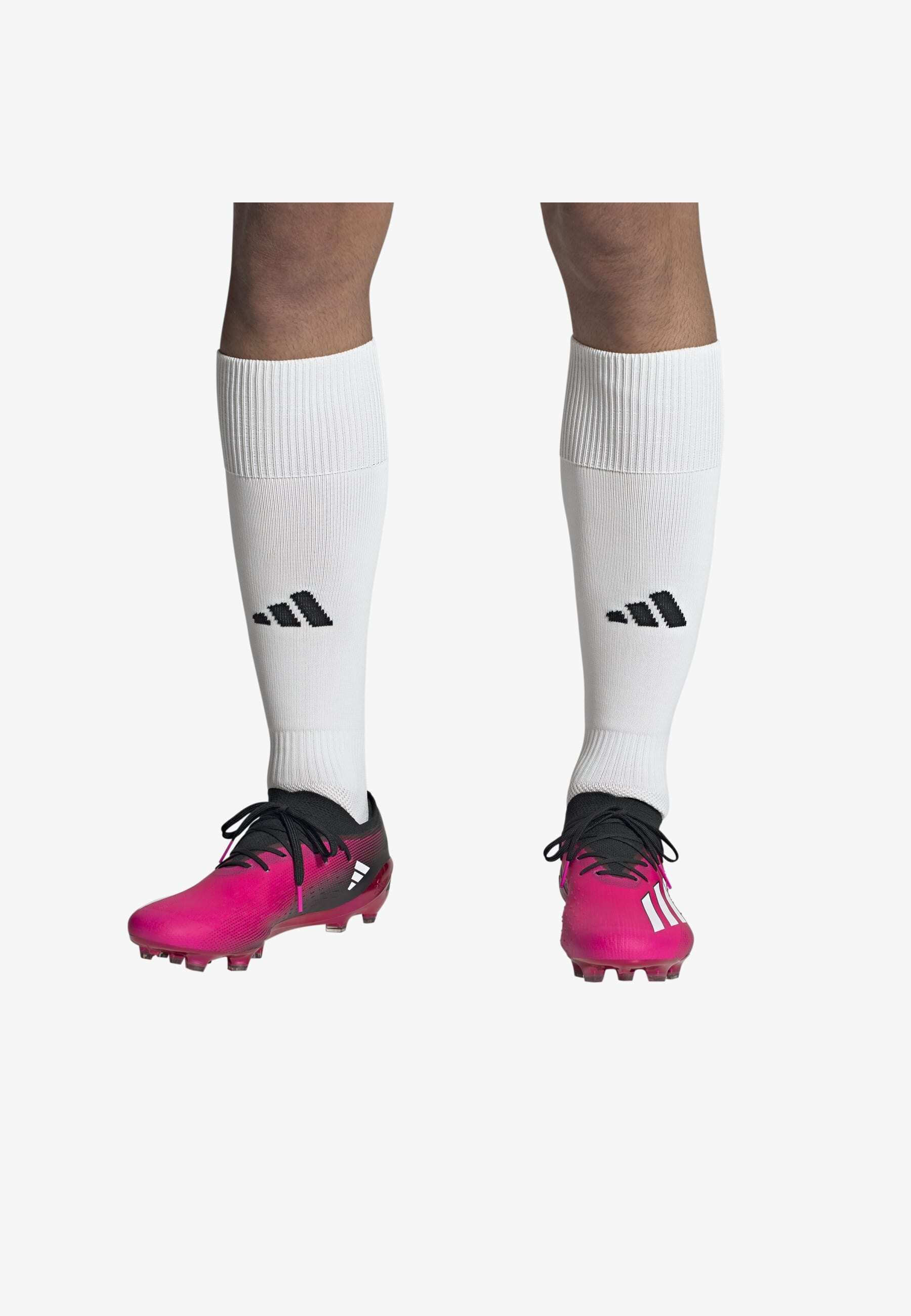 white and pink adidas football boots