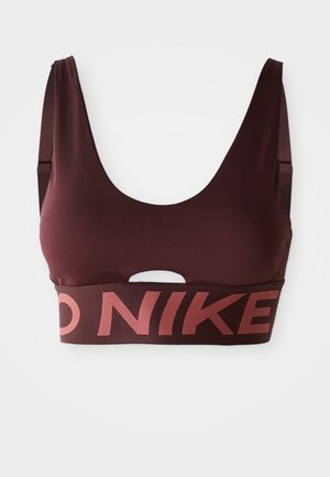 Tumman viininpunainen urheiluliivi leveillä olkaimilla, avokohdan leikkaus rinnan alla ja rohkea Nike-logo elastisessa nauhassa.