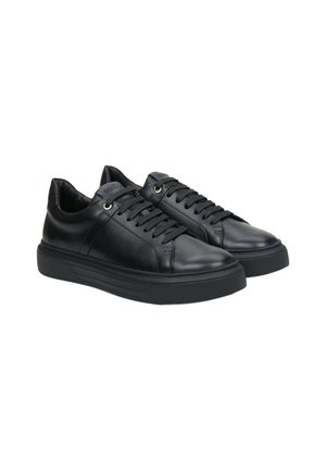 Black leather sneakers with a smooth texture, featuring round toe, lace-up design, metal eyelets, and a thick rubber sole.