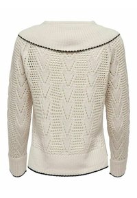 Gestrickter Pullover in Creme mit großem Kragen, der ein Chevron-Muster, offene Webart und schwarze, gewellte Akzente am Kragen und an den Manschetten aufweist.