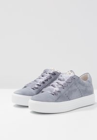 Gray suede sneakers with satin ribbon laces, featuring a white rubber sole and small pearl accents on the tongue.