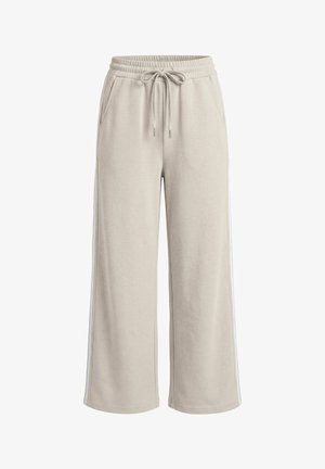 Beiget väriset, leveälahkeiset collegehousut, joissa on joustava vyötärönauha, kiristysnauha, sivutaskut ja hillityt sivuraidat, esillä valkoisella taustalla.