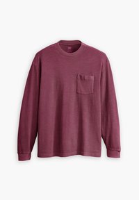 Camiseta de manga larga color burdeos, hecha de algodón, con un bolsillo en el pecho y un cuello redondo. Incluye un sutil detalle del logo en el bolsillo.