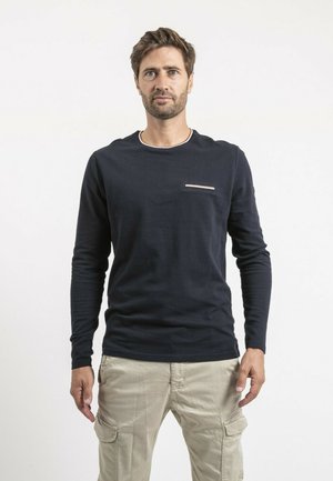 T-shirt bleu marine à manches longues avec un col rond et une petite poche poitrine présentant une accent rayé ; tissu texturé.