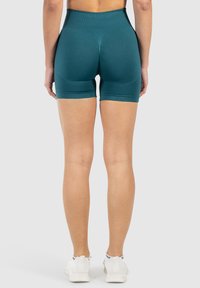Teal hoch taillierte Shorts aus einem dehnbaren Stoff, mit einem figurbetonten Design und einer glatten Textur. Eignen sich hervorragend für Sportbekleidung.