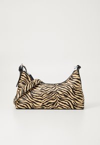 Tote bag in a tiger stripe pattern, featuring a beige base with black stripes, smooth texture, and black accents. Adjustable strap included.