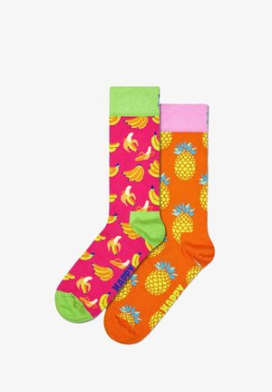 Colorful socks featuring a pink background with banana patterns and an orange background with pineapple designs. Green and pink accents on the cuffs.