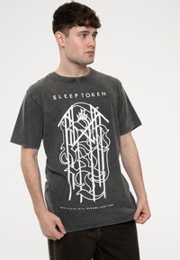 Grey cotton t-shirt with short sleeves, featuring white graphic design and text that reads "SLEEP TOKEN" and "THIS PLACE WILL BECOME YOUR TOMB."