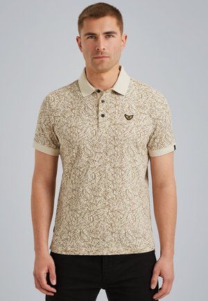 Polo beige con un motivo astratto marrone, maniche corte, colletto a contrasto e un piccolo logo ricamato sul petto.