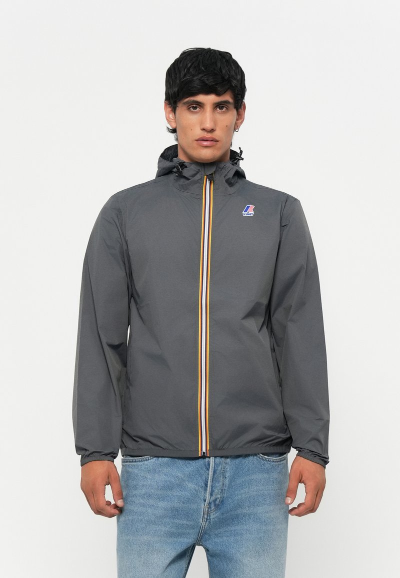 Gray windbreaker jacket with a hood, featuring a front zipper with orange and white stripes, and a logo on the left chest.