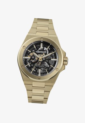 Gouden automatische horloge met een zwart skeleton-dial, zilveren accenten en een metalen schakelarmband. Bevat een ronde kast en een gestructureerde afwerking.
