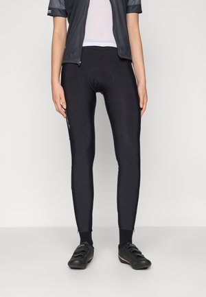 Black cycling tights made from stretchy fabric, featuring a padded seat for comfort, with slim design and ankle zippers for easy wear.