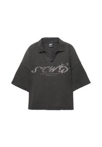 Oversized black polo shirt with a collar, short sleeves, and a distressed texture. Features a graphic print in light gray on the front.