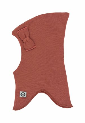 Rust-colored knitted children's balaclava with a small bow on the side and a sewn-on brand label near the bottom edge.