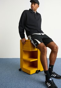 adidas Originals ADIDAS NTS RADIO ALLOVER PRINTED SUPERSTAR TRACK PANTS - Teplákové kalhoty - black