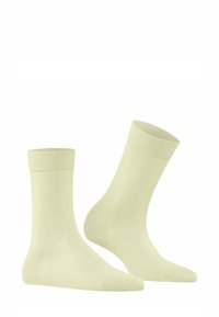Calzini in cotone giallo pallido con una texture liscia, polsini a coste e un design semplice. Presenta una lunghezza alla caviglia adatta per un uso quotidiano.