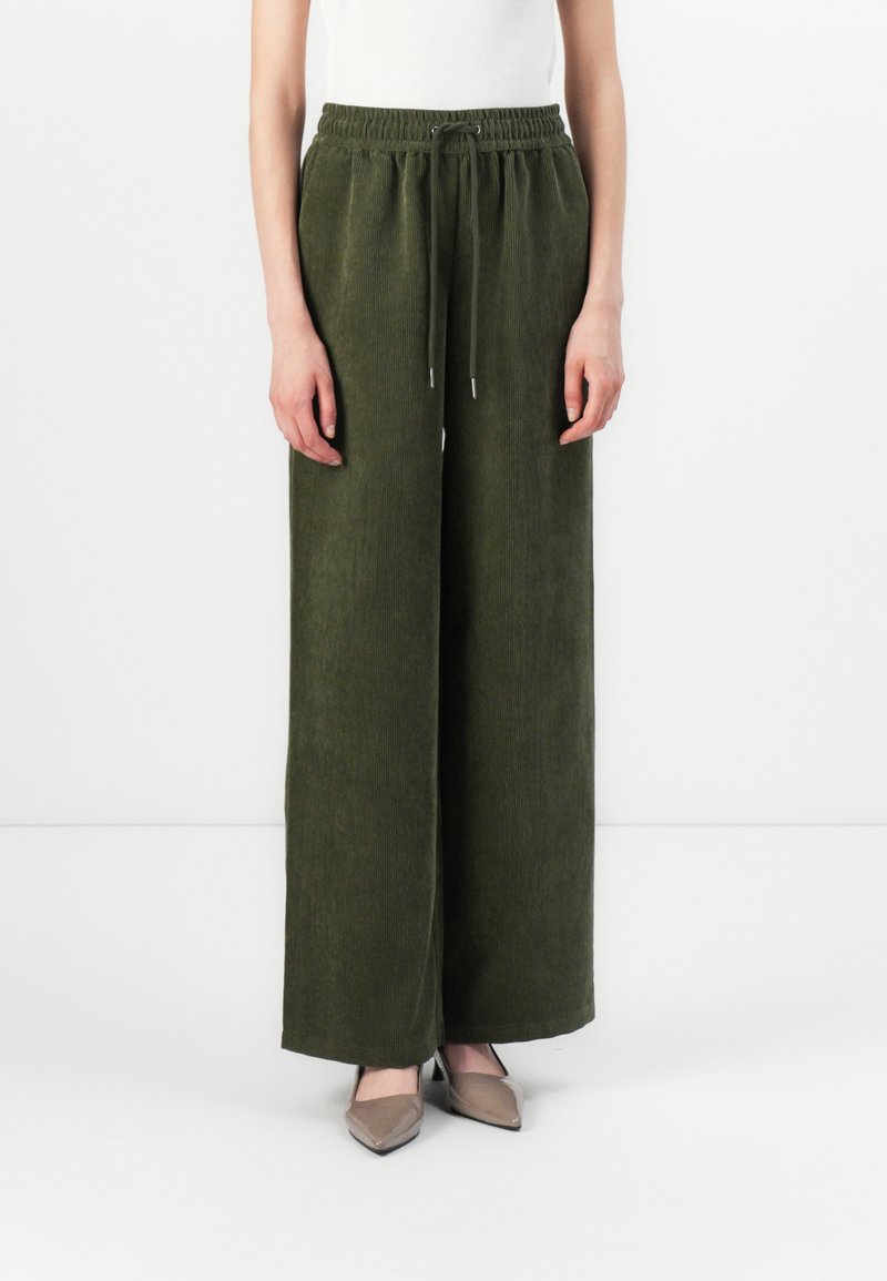 Olive green wide-leg pants made of corduroy fabric, featuring an elastic waistband with a drawstring and a soft textured finish.