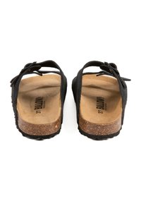 Sandales à glissière en suede noir avec semelle en liège, design ouvert à l'arrière, semelle en caoutchouc texturé et nœud décoratif sur la sangle. Taille 37.