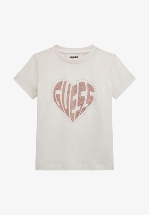 White cotton t-shirt featuring a large heart-shaped "GUESS" logo in a textured, light pink design at the center. Short sleeves.