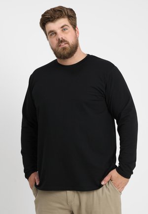 Camiseta negra de manga larga hecha de tejido ligero, con un cuello redondo y un corte relajado. Diseño sin costuras, sin patrones ni gráficos.