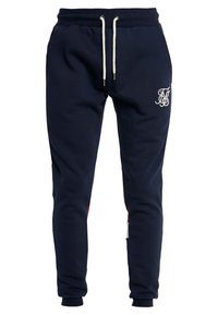 Námořnické modré teplákové kalhoty vyrobené z bavlněné směsi, s elastickým pasem na šňůrku, bočními kapsami a bílým vyšívaným logem.