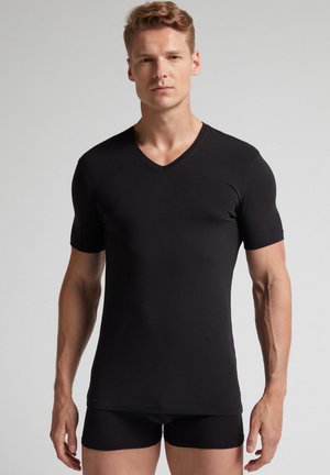 Black short-sleeve V-neck T-shirt in a slim-fit design, made from soft, stretchy fabric, paired with black fitted shorts.