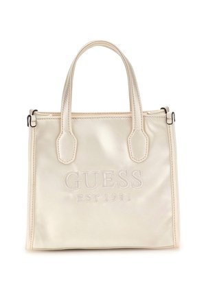 Cremefarbene Guess Tote-Tasche mit doppelten Griffen und „GUESS EST 1981“ auf der Vorderseite bestickt.