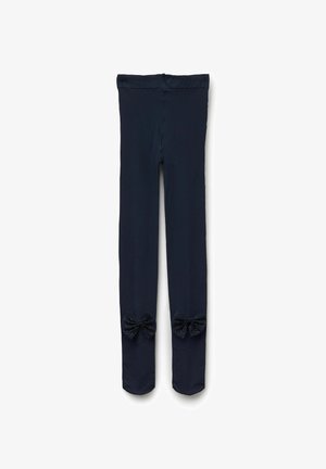 Granatowe legginsy wykonane z miękkiego materiału z dekoracyjnymi kokardkami przy dolnych nogawkach, ozdobione wzorem w kropki. Elastyczny pas.