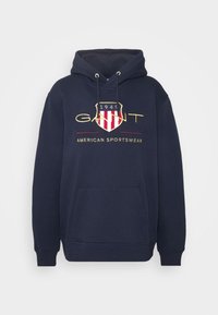 Felpa blu navy in cotone misto, con tasca frontale, cappuccio regolabile e logo scudo rosso e bianco con dettagli dorati.