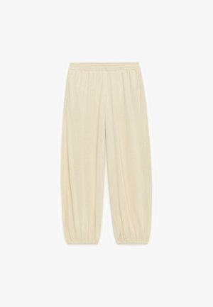 Svijetlosmeđe hlače s elastikom u struku i ručnim manžetama. Mekani materijal, sužen kroj i bočne džepove. Pogodne za ležernu odjeću.