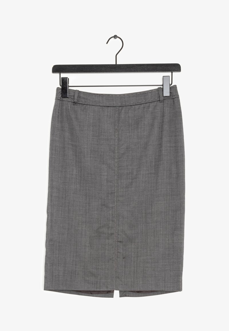 Jupe crayon grise longueur genou avec passants pour ceinture accrochée à un cintre noir sur fond blanc.