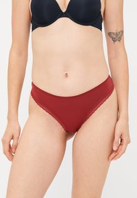Burgundy cotton panties with a scalloped lace trim and a classic brief cut, featuring smooth fabric and a comfortable fit.