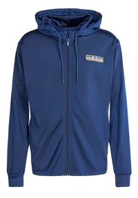 Námornícka zipová mikina vyrobená z hladkej látky, s kapucňou na šnúrku, elastickými manžetami a zlatým logom Adidas na hrudi.