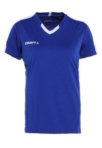 Blå atletisk T-shirt lavet af fugttransporterende stof, med hvide accenter på ærmerne og V-hals design, med "CRAFT" logo trykt.