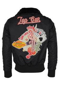 Svart bomberjacka med en krage av fuskpäls, prydd med färgglada broderade grafiker, inklusive "Top Gun", spelkort och en pin-up design.