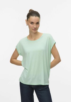 Light green short-sleeve t-shirt with a relaxed fit and a round neckline, made from soft fabric, worn with dark blue jeans.