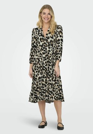 Leopardenmuster Midi-Kleid mit langen Ärmeln, tiefem V-Ausschnitt, gestuftem Rüschensaum und leichtem Stoff; ergänzt durch schwarze flache Schuhe.