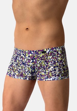 Mannelijke torso met nauwsluitende boxershorts met een abstract paars, groen en wit patroon tegen een effen achtergrond.